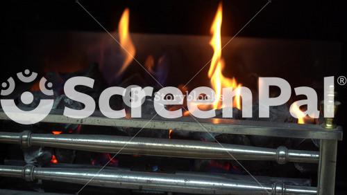 A Cozy Evening By The Fireplace In The House When It's Cold And Snowing Outside The Window